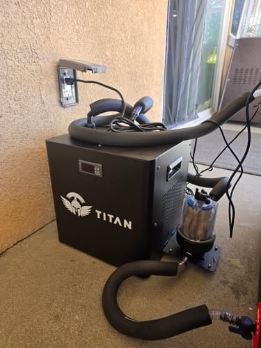 Customer review photo of Titan chiller outdoors, insulated hoses coiled, inline filter and pump connected near GFCI outlet