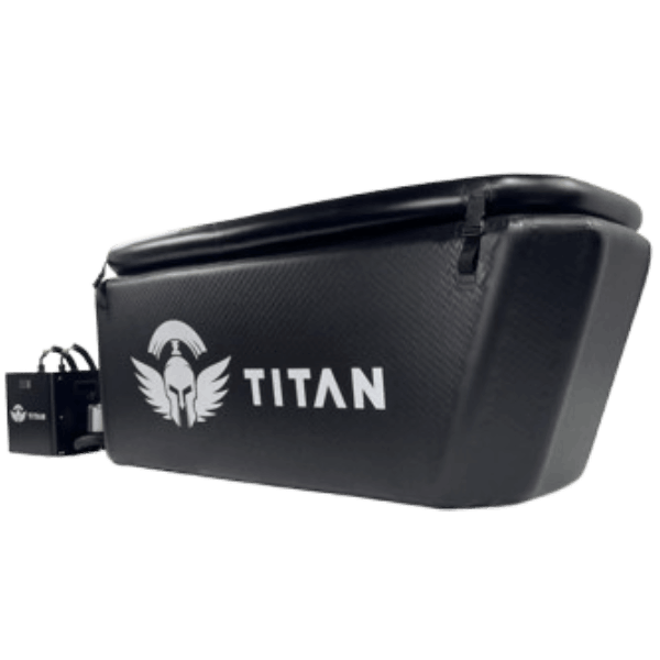 Side-by-side comparison graphic: on the left, the Titan Triumph cold plunge (black drop-stitch tub with Titan logo and connected chiller); on the right, the larger Triumph XL in the same style; ‘VS’ centered between them.