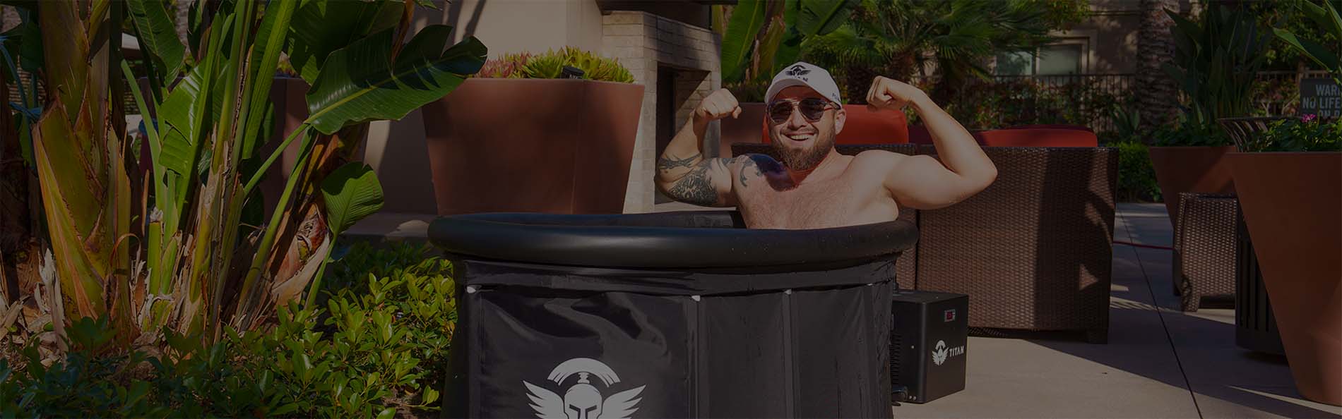 Man flexing muscles in a Titan Bravo XL Cold Plunge outside